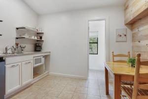 a kitchen with white cabinets and a wooden table at Wimberley Log Cabins Resort and Suites- Unit 2 in Wimberley