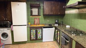 a kitchen with a sink and a stove top oven at Rego de Cora By Oktheway in Valcarría