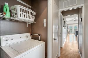 a white washing machine in a kitchen with a hallway at Ricks River Haus in Canyon Lake