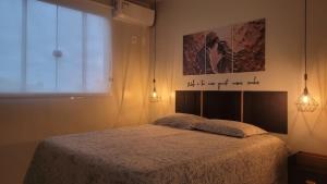 a bedroom with a bed and a poster on the wall at Marques Home in Porto Belo +98 photos
