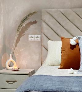 a bedroom with a bed and a side table with a lamp at Riad Sor in Essaouira