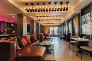 a hotel lobby with couches and tables and chairs at Montrose at Beverly Hills in Los Angeles