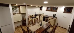 a kitchen with a table with a cat sitting on it at Woodlight Loft - Sauna & Nature Escape near Rothenburg ob der Tauber - Self Check-in in Diebach +22 photos