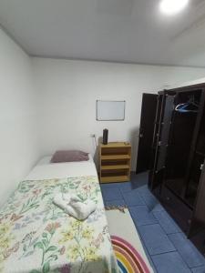 a bedroom with a bed and a dresser in it at Apartamentos Novoa in San José