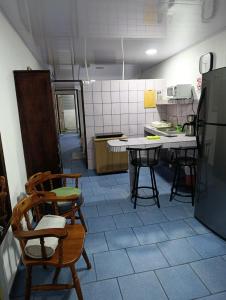 a kitchen with chairs and a table in it at Apartamentos Novoa in San José