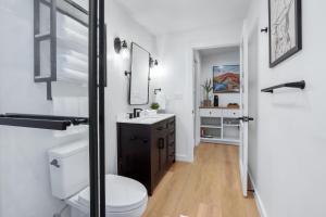 a bathroom with a white toilet and a sink at Cowboy Casita in Wimberley