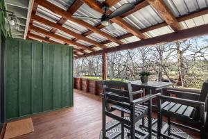 a patio with a table and chairs on a deck at Cowboy Casita in Wimberley