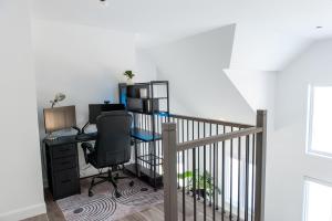 an office with a desk with a computer and a chair at Cozy Cottage, The Getaway in Quebec in Brownsburg