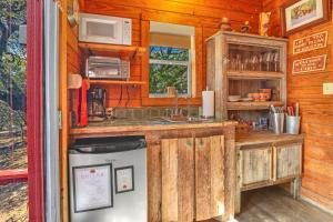 a kitchen with a sink and a stove in a cabin at Cozy Cabin in Wimberley