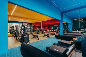a gym with rows of treadmills and machines at Secrt Escalante Premium Studio AC in San Pedro