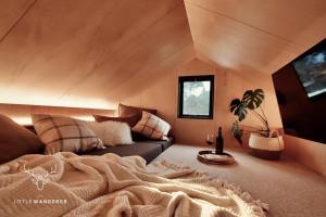 a living room with a bed and a couch at The Little Wanderer in Queenstown