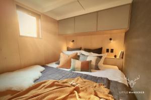 a bedroom with a large bed and a window at The Little Wanderer in Queenstown