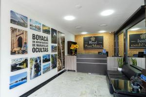 a lobby of a hotel with posters on the wall at Hotel Plaza Muisca in Tunja