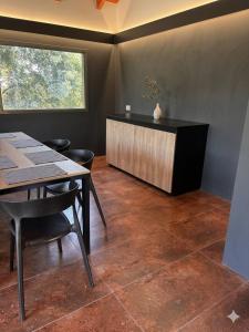 a dining room with a table and a counter at Cabaña julian in Villa Berna
