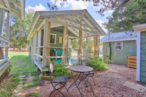 a tiny house with a table and chairs outside at Creekside Cabins - The Nest in Wimberley