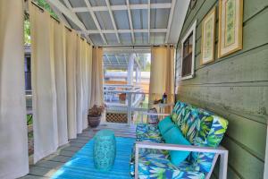 a covered porch with a couch and a table at Creekside Cabins - The Nest in Wimberley
