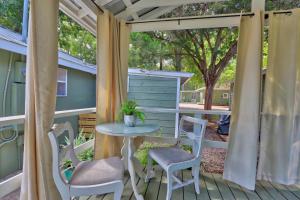 a patio with a table and chairs on a deck at Creekside Cabins - The Nest in Wimberley