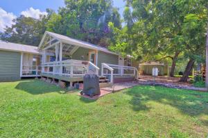 a home with a large yard with a house at Creekside Cabins - The Texan in Wimberley