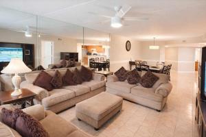 a living room with couches and a dining room at Saida Towers IV #108 condo in South Padre Island