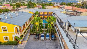 an aerial view of a building with cars parked in a parking lot at Hotel Antigua Comayagua in Comayagua