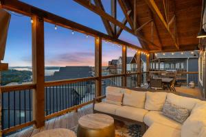 a living room with a couch on a balcony at On the Rocks Lodge in Branson