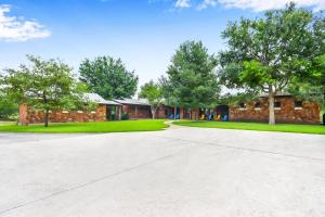 an empty driveway in front of a brick building at River Nest in Wimberley +44 photos