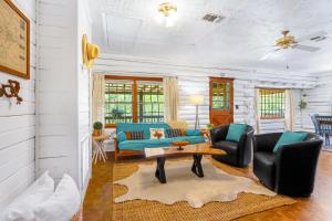 a living room with a couch and a table at Creekside Vista Escape - Cabin in Wimberley