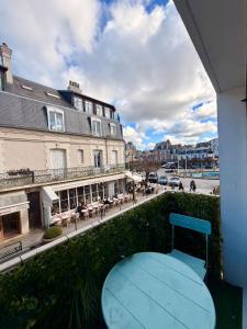 a blue bench sitting on the side of a building at Le Studio Morny in Deauville