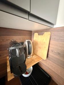 a counter with a toaster on a wooden counter top at Le Studio Morny in Deauville