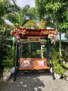 a bus stop with a bench with flowers on it at Villa Rosalía con Piscina Climatizada in Jarabacoa