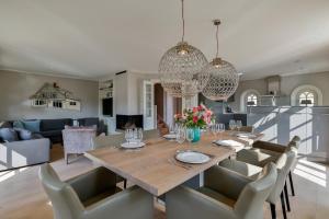 a dining room and living room with a table and chairs at Sand Beach in Rantum