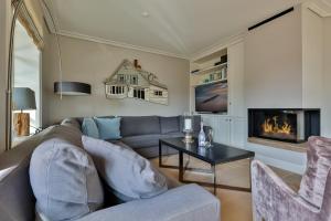 a living room with a couch and a fireplace at Sand Beach in Rantum