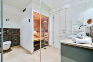 a bathroom with a shower and a toilet and a sink at Sand Beach in Rantum +32 photos