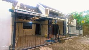 a house with a gate in front of it at Homestay Karimun in Grogol +3 photos