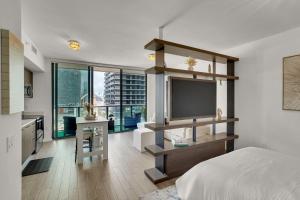 a bedroom with a bed and a flat screen tv at Azure Miami - Studio Apartment with Stunning City & Bay Views! in Miami +17 photos