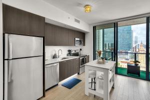 a kitchen with a refrigerator and a large window at Azure Miami - Studio Apartment with Stunning City & Bay Views! in Miami