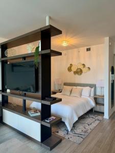 a bedroom with a large bed and a television at Azure Miami - Studio Apartment with Stunning City & Bay Views! in Miami