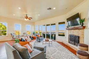 a living room with a fireplace and a tv at Riviera Lake House in Canyon Lake +29 photos