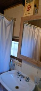 a bathroom with a sink and a mirror at Anto'n casa de montaña in Potrerillos +48 photos
