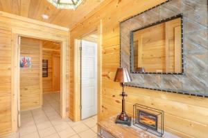 a log home hallway with a fireplace and a mirror at Wimberley Log Cabins Resort and Suites- The Oak Lodge in Wimberley