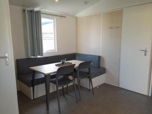 a room with a table and chairs and a window at Breebos Chalet near Antwerp Camp in Rijkevorsel