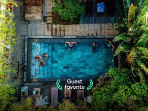 a group of people swimming in a swimming pool at 9Station Hostel & Bar Phu Quoc in Phú Quốc
