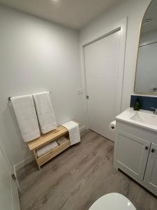 a bathroom with a sink and a toilet and a mirror at Hidden Gem in Airdrie +11 photos