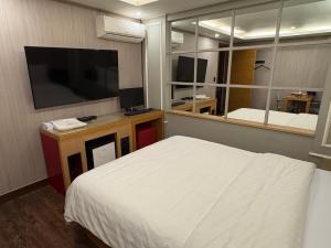 a bedroom with a bed and a large mirror at Rosemari Hotel in Seoul