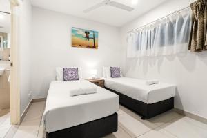 a bedroom with two beds and a sink in it at Reef-side Splendour City Vistas - Pool - Workspace in Darwin +42 photos