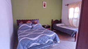 a bedroom with two beds and a window at HOSPEDAJE EIMy in Purmamarca