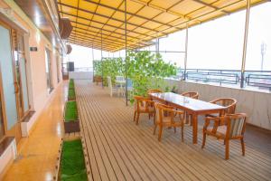 a patio with a table and chairs on a balcony at Milliy Hotel - Namangan city in Namangan
