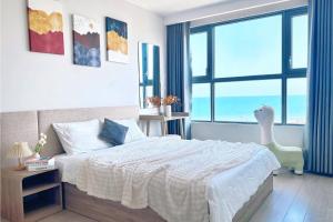 a bedroom with a bed and a large window at The Song Luxury Near Beach Apartment - Căn hộ Nghỉ Dưỡng Cao Cấp Cạnh Biển - Moonlight Homestay in Vung Tau