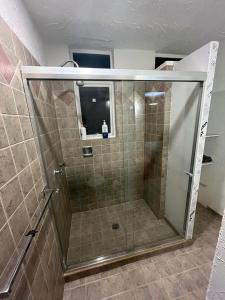 a shower with a glass door in a bathroom at SúperAnfitrión Coyoacán King 1 in Mexico City