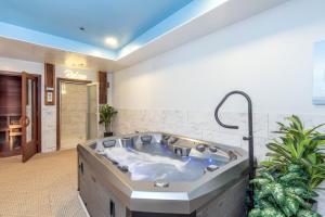 a jacuzzi tub in a room with plants at Bear Creek Lodge 203C Hotel Room in Telluride +4 photos